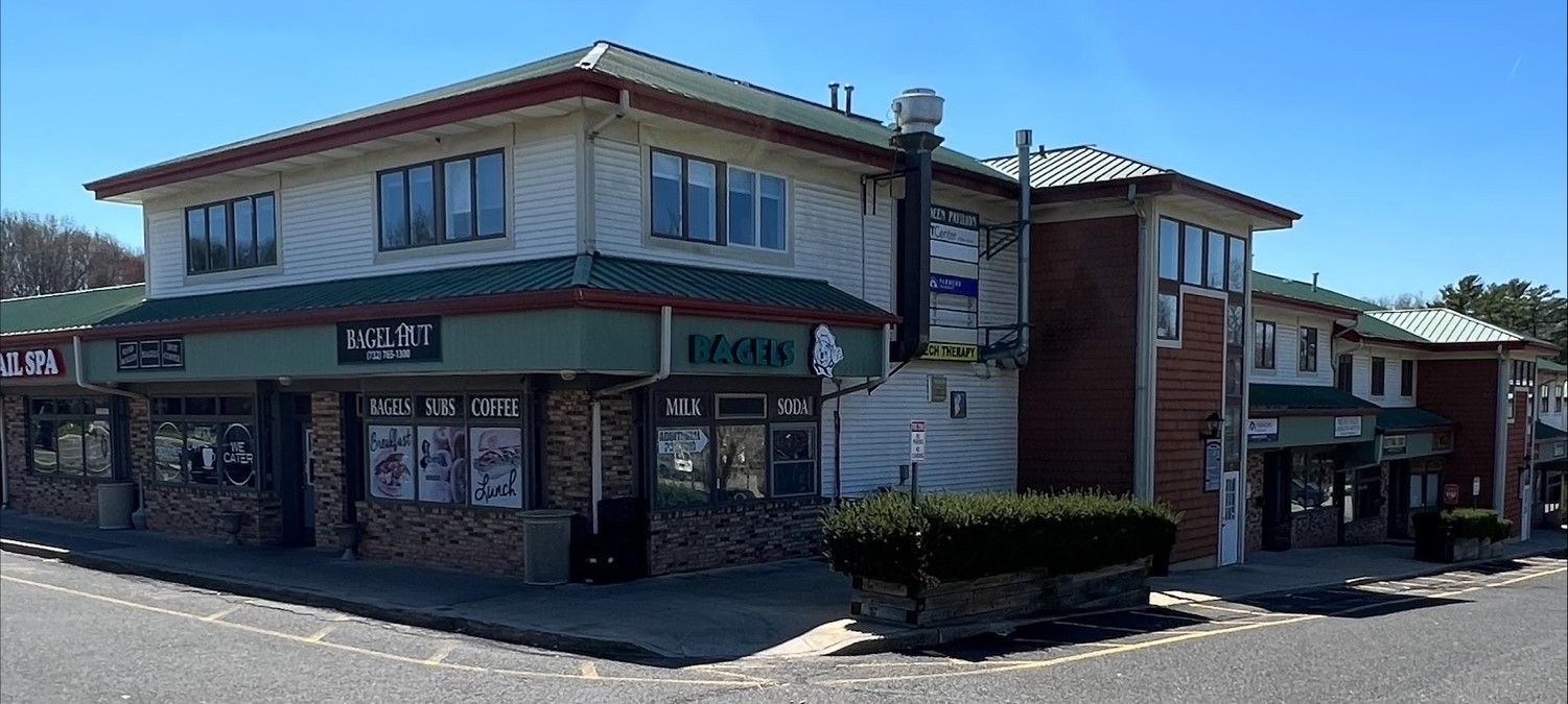 A building with a street sign on the corner.