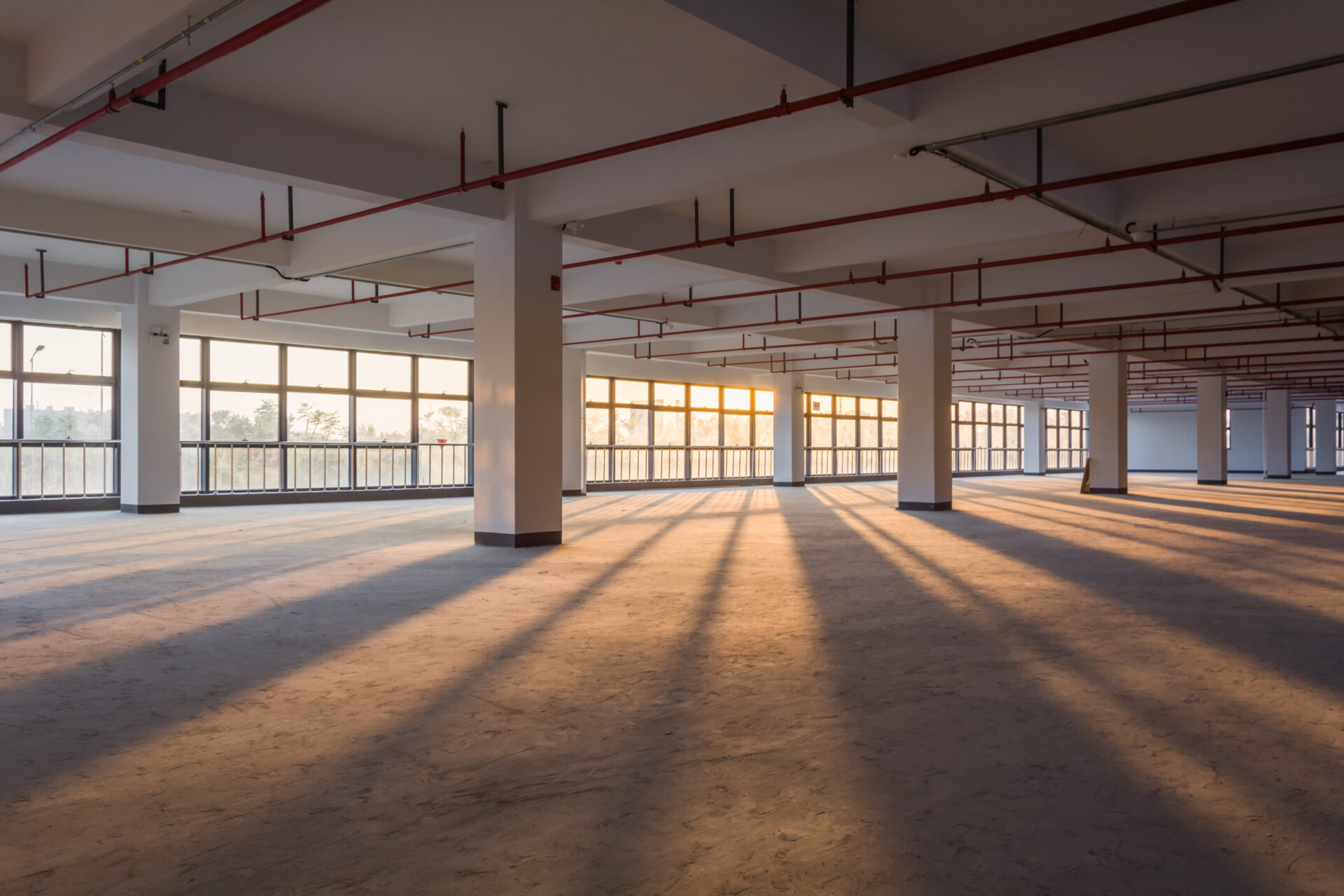 A large empty room with lots of windows.