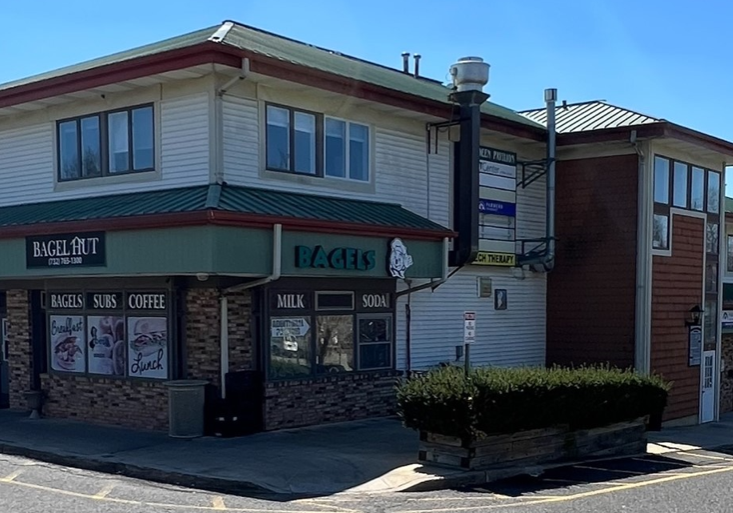 A building with a street sign on the corner.