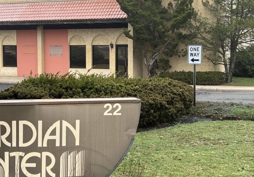 A sign in front of a building that says meridian center.