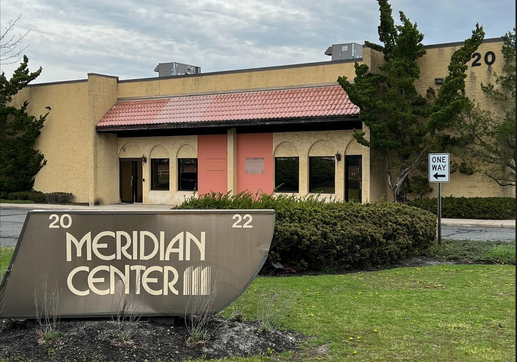 A building with a sign that says meridian center.